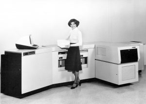 Lady standing at a vintage photocopier